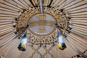 a chandelier with birds in a wooden ceiling at Komay Yurt Camp Karakol in Karakol