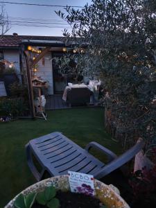 a garden with a bench and a table in the yard at Grain de folie in Beaune +1 photo