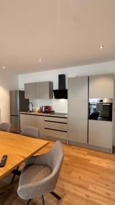 a kitchen with a table and chairs in a room at AMAO-Ivory - Business Apartment - 6 Guests - Parking in Offenburg