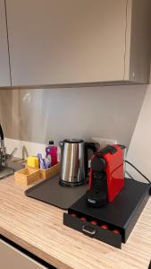 a red toaster sitting on top of a kitchen counter at AMAO-Ivory - Business Apartment - 6 Guests - Parking in Offenburg