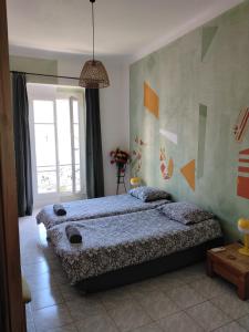 a bedroom with a large bed and a window at Chez Brigitte Guesthouse in Nice