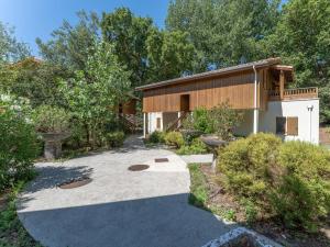 a house with a driveway leading to a building at Vacancéole - Les Rives du Lac in Lacanau