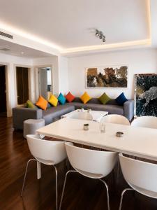 a living room with a couch and a table and chairs at The Sign Highlight Hotel in Bodrum City