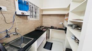 a small kitchen with a counter and a sink at Boutique Bungalow 458 in Secunderabad +53 photos