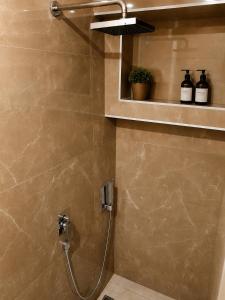 a bathroom with a shower with a shower head at FORUM Square in Skopje