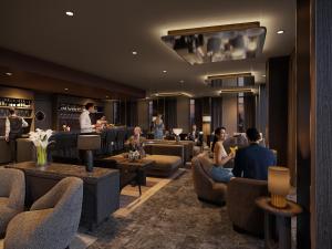 a lobby of a hotel with people sitting in chairs at ATLANTIC Hotel Frankfurt in Frankfurt