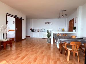 a kitchen and dining room with a table and chairs at มาภูโฮมสเตย์ in Chiang Rai