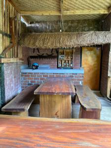 two wooden benches sitting in front of a bar at Upus Homestay in Tetebatu
