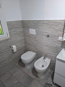 a bathroom with a toilet and a sink at Nazem Holiday in Comunanza +3 photos