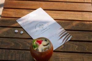 a cup of food sitting on top of a wooden table at Perla Del Mare in Alikanas
