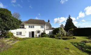 a large white house with a large yard at Old Weavers in Corsley