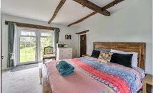 a bedroom with a large bed and a window at Old Weavers in Corsley