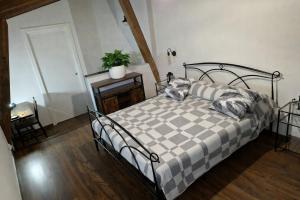 a bedroom with a bed with a checkered blanket at Nazem Holiday in Comunanza
