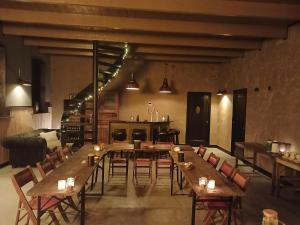 a large room with tables and chairs and a kitchen at De Sarrieshut in Houwerzijl