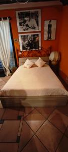 a bedroom with a bed with pictures on the wall at B&B Vista su Roma in Marco Simone