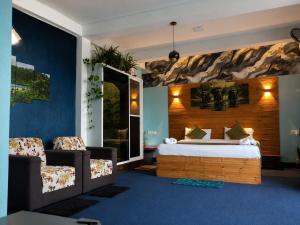 a hotel room with a bed and two chairs at Off grid Ella Homestay in Ella