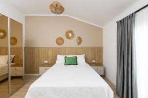 a bedroom with a bed with a green pillow on it at Eliz Paradise By Panjur in Alanya +35 photos