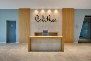 a reception desk in a building with a sign on the wall at Calithea Residence in Kavarna