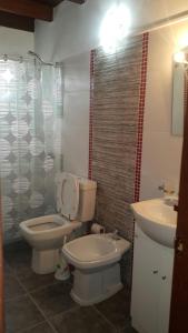 a bathroom with a toilet and a sink at Casa Nuestro Sueño in Punta Del Diablo