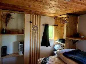 a bedroom with a bed in a room with wooden ceilings at Cosy camping in Crots