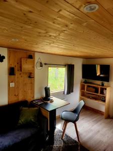 a living room with a couch and a table at Cosy camping in Crots