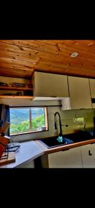 a small kitchen with a sink and a window at Cosy camping in Crots