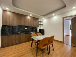 a kitchen and dining room with a table and chairs at MeySunset Hotel Phu Quoc in Phú Quốc