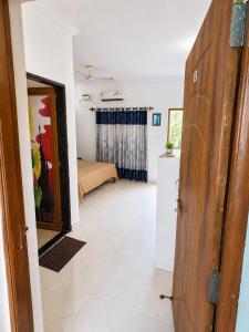 a room with a door leading to a bedroom at Aurevia Stays - 400m from beach in Calangute +1 photo