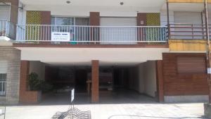 a balcony of a building with a table on the ground at Arco Iris in Miramar