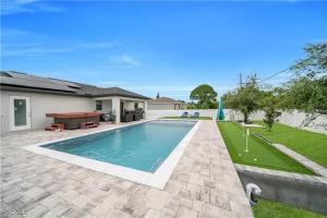 a swimming pool in the backyard of a house at Southwest Florida Paradise in Cape Coral