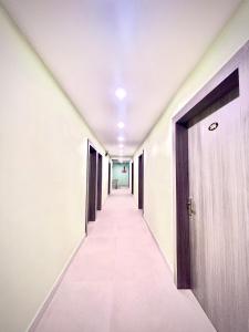 a corridor of an office building with a door at Hotel Vira in Cuttack