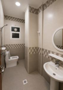 a bathroom with a shower and a sink and a toilet at RED Bn Saif in Salalah +40 photos