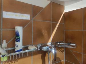 a bathroom with a toothbrush holder and a sink at Frank's Backpackers in Helmond
