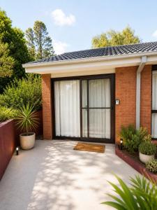 a home with a patio with a large glass door at Garden Studio with Private Patio in Wentworth Falls