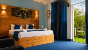 a bedroom with a bed and a large window at Off grid Ella Homestay in Ella