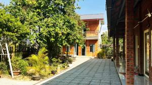 a cobblestone street in front of a building at Cat Tien Backpackers Hostel in Cat Tien