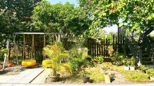 a garden with a fence and a lot of plants at Cat Tien Backpackers Hostel in Cat Tien