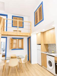 a small kitchen and dining room with a loft bed at Casa Trainêra in Nazaré +4 photos
