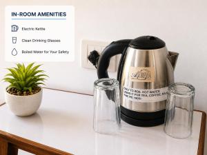 a tea kettle and two glasses on a counter at Aurevia Stays - 400m from beach in Calangute