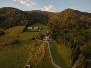 an aerial view of a house on a hill at Apartamenty Pod Horodkiem in Cisna +53 photos