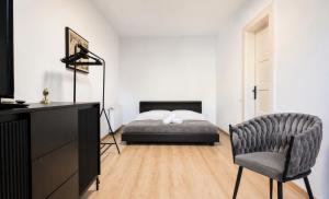 a bedroom with a bed and a desk and a chair at Luxurious & Spacious Residence in the Heart of Brașov in Braşov