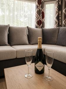 a bottle of champagne and two wine glasses on a table at Au 7cent14 in Marcilly-sur-Eure