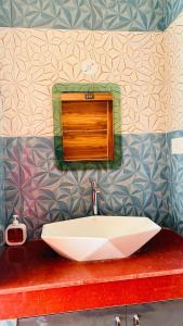 a bathroom with a white sink on a counter at Shreevanya Inn in Ayodhya