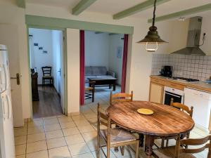 a kitchen and dining room with a table and chairs at Gite Les Bannes in Saint-Sauves- dʼAuvergne
