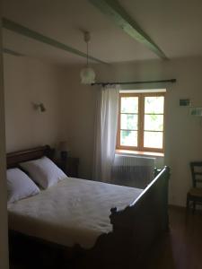 a bedroom with a large bed and a window at Gite Les Bannes in Saint-Sauves- dʼAuvergne
