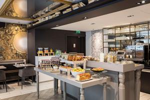 a bakery with a buffet of food on display at Hotel Indigo Paris - Opera by IHG in Paris