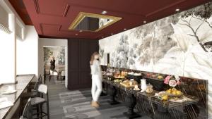 a woman walking through a restaurant with a buffet at Hotel Indigo Paris - Opera by IHG in Paris