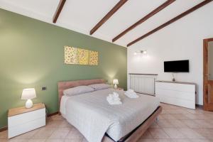 a bedroom with a bed and a tv on a wall at Cà da Trûcca in Varazze