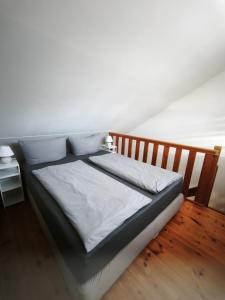 a bed with white sheets and pillows in a room at Juliusruh Strandparadies 12 in Juliusruh