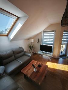 a living room with a couch and a table at Juliusruh Strandparadies 12 in Juliusruh